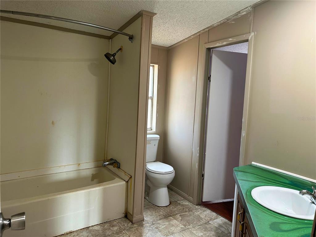 9867 Jerome Drive New Port Richey, FL 34654 - Photo 23 of 30 a bathroom with a sink toilet and shower