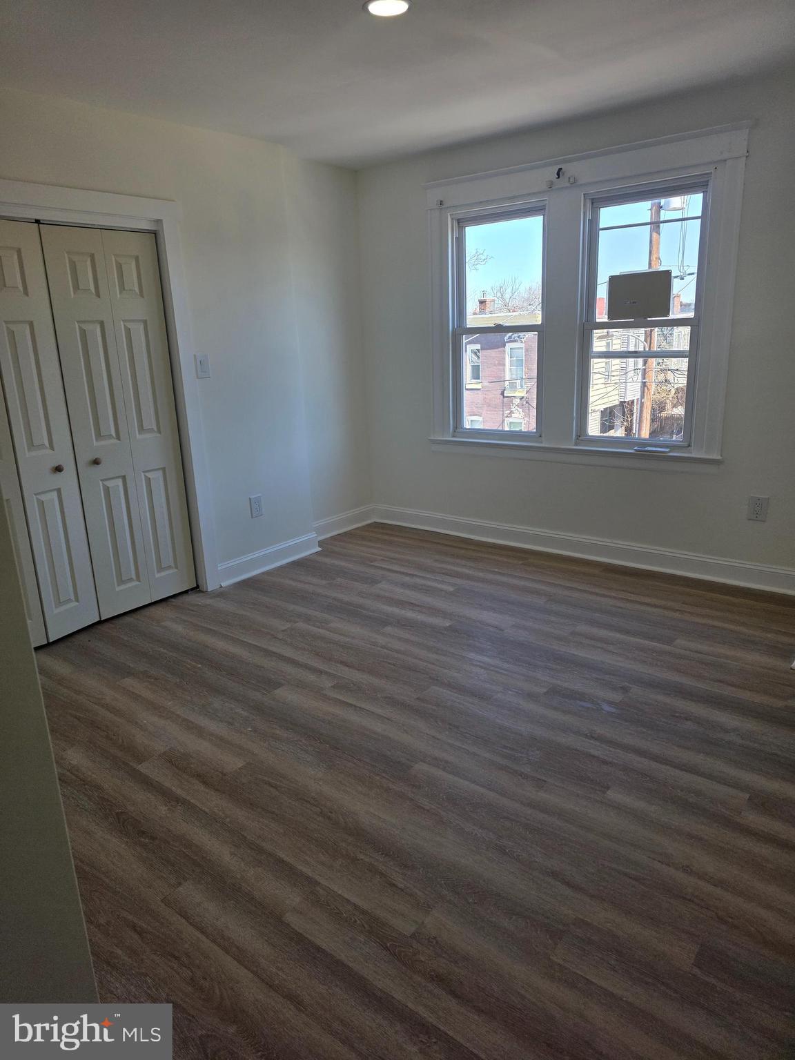 5901 Belmar Street, Unit 3 Philadelphia, PA 19143 - Photo 5 of 10 a view of an empty room with wooden floor and a window