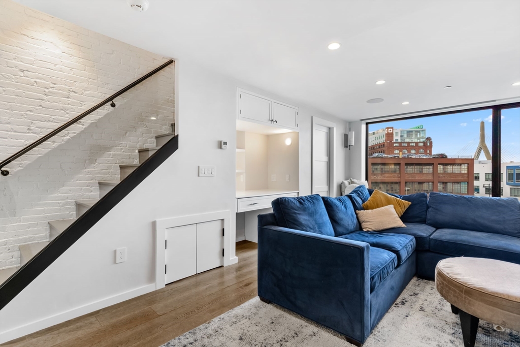 53 Snow Hill Street Boston, MA 02113 - Photo 11 of 35 a living room with furniture and a large window