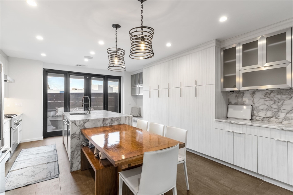 53 Snow Hill Street Boston, MA 02113 - Photo 2 of 35 a dining room with a wooden table and chairs