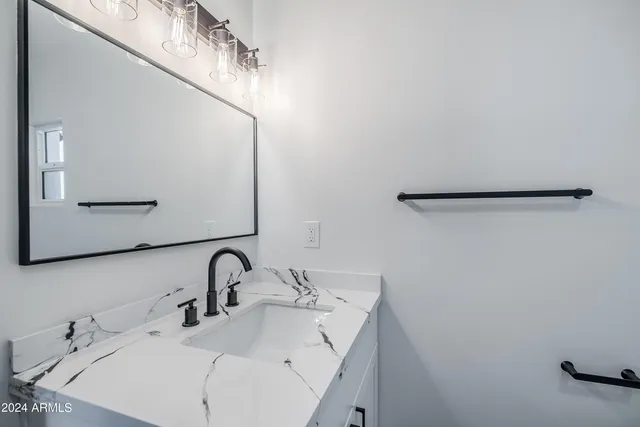 a bathroom with a sink and mirror