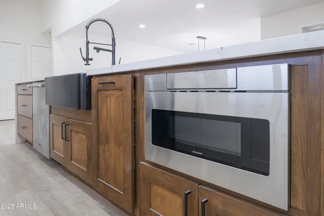 a kitchen with stainless steel appliances a stove microwave and cabinets