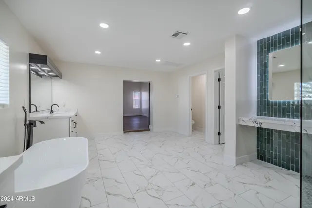 a bathroom with a toilet sink and shower