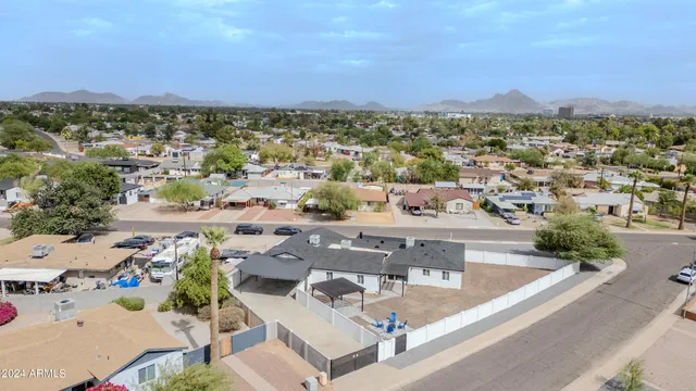 a large kitchen with kitchen island a stove a refrigerator a sink dishwasher and a oven with wooden floor