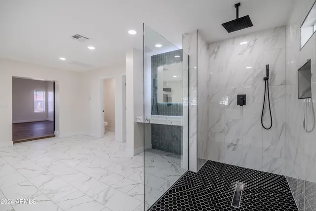 a bathroom with a shower and a mirror