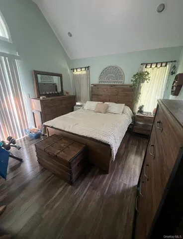 a bedroom with a bed and window