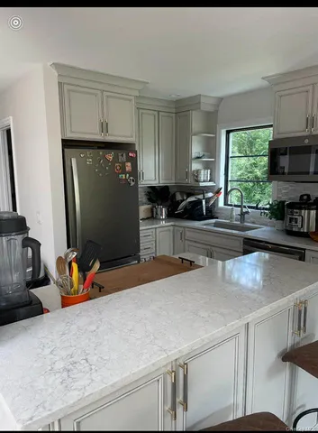 a kitchen with granite countertop a sink cabinets and window