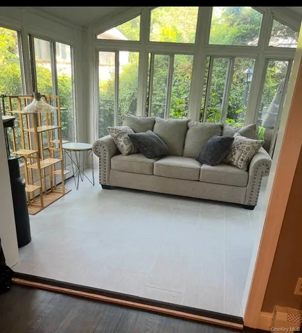 a living room with furniture and large window
