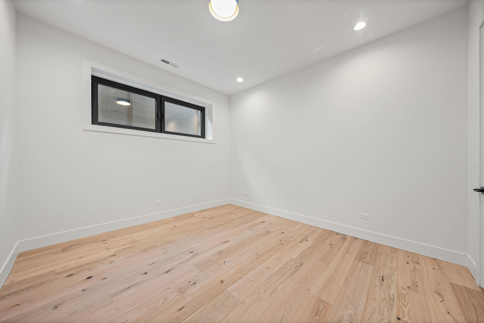 2341 West Belden Avenue, Unit 1 Chicago, IL 60647 - Photo 21 of 24 a view of a room with wooden floor and white walls