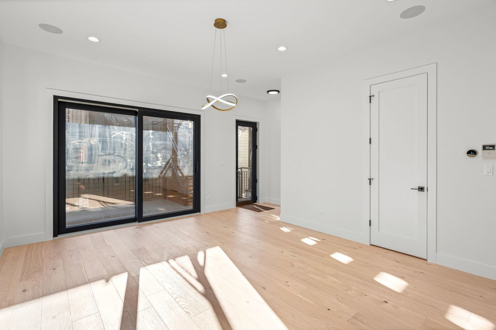 2341 West Belden Avenue, Unit 1 Chicago, IL 60647 - Photo 8 of 24 a view of empty room with floor to ceiling window