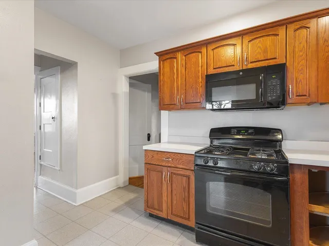 a kitchen with stainless steel appliances granite countertop a stove microwave and cabinets