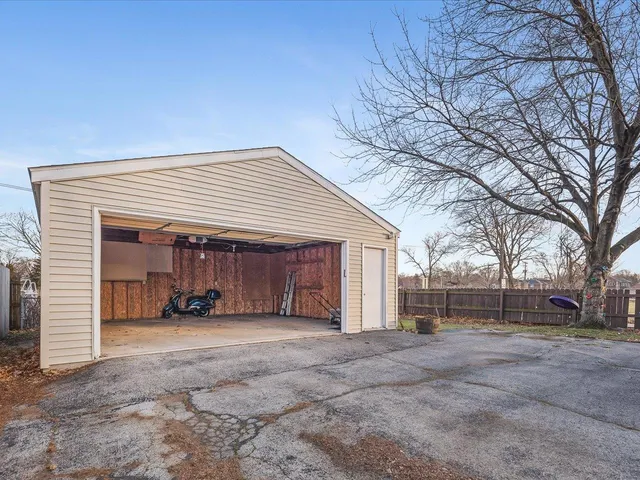a view of a house with a yard and garage