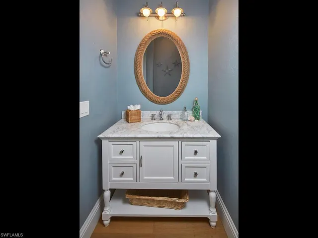 a bathroom with a sink mirror vanity and toilet