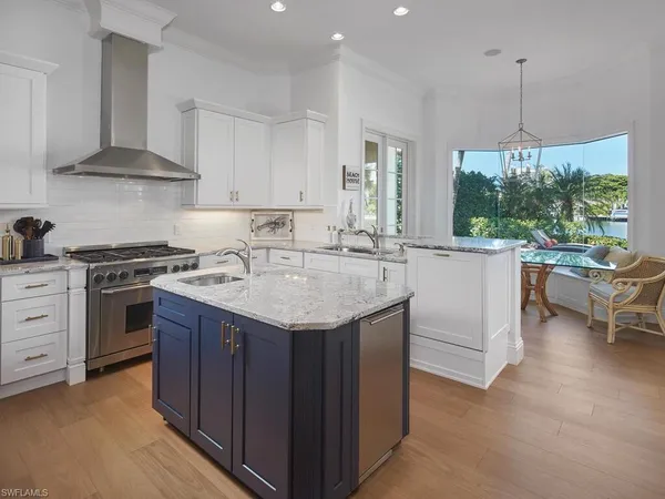 a kitchen with granite countertop a sink stove and cabinets