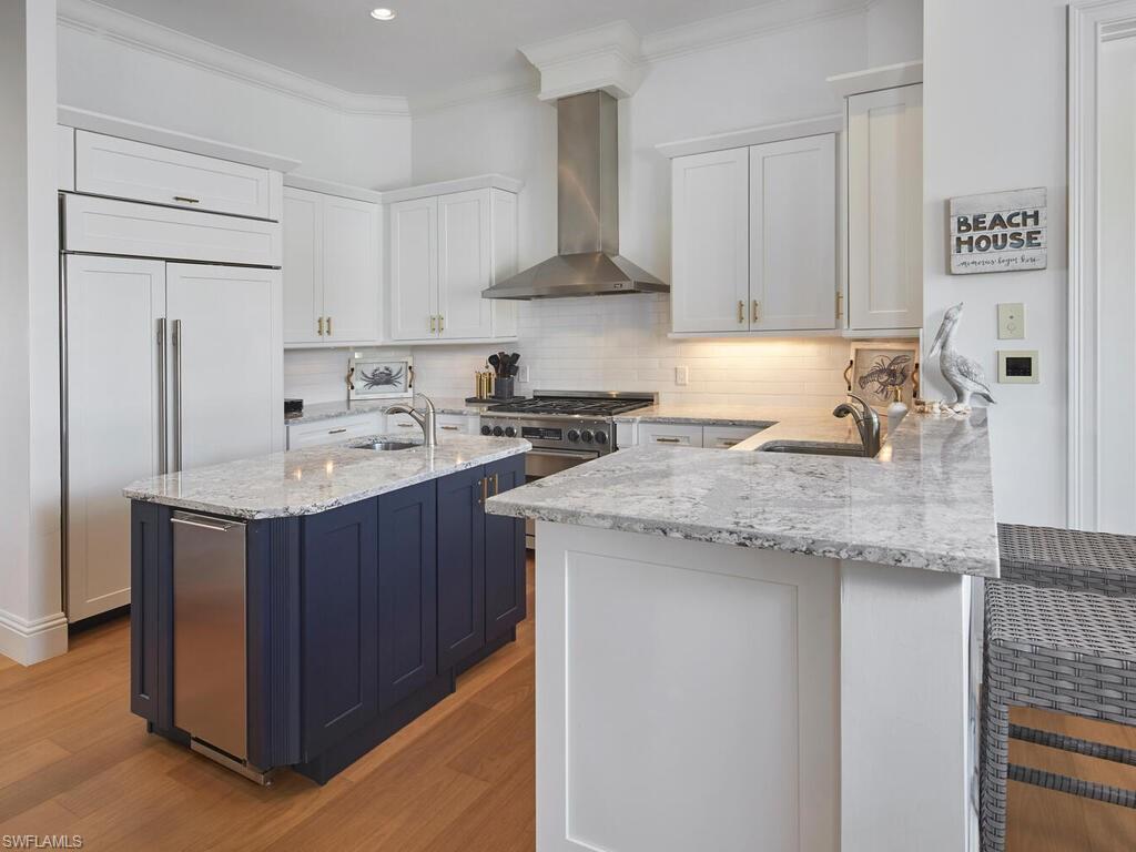 377 Pirates Bight Naples, FL 34103 - Photo 14 of 44 a kitchen with stainless steel appliances granite countertop a sink stove and refrigerator