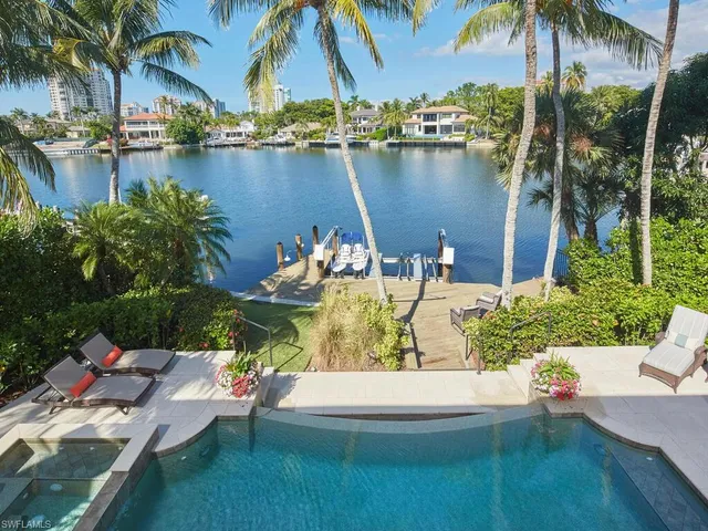 a view of a lake with couches and chairs