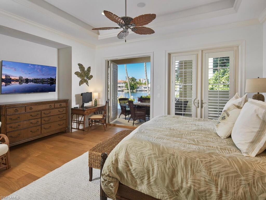 377 Pirates Bight Naples, FL 34103 - Photo 20 of 44 a bed sitting in a spacious bedroom next to a window