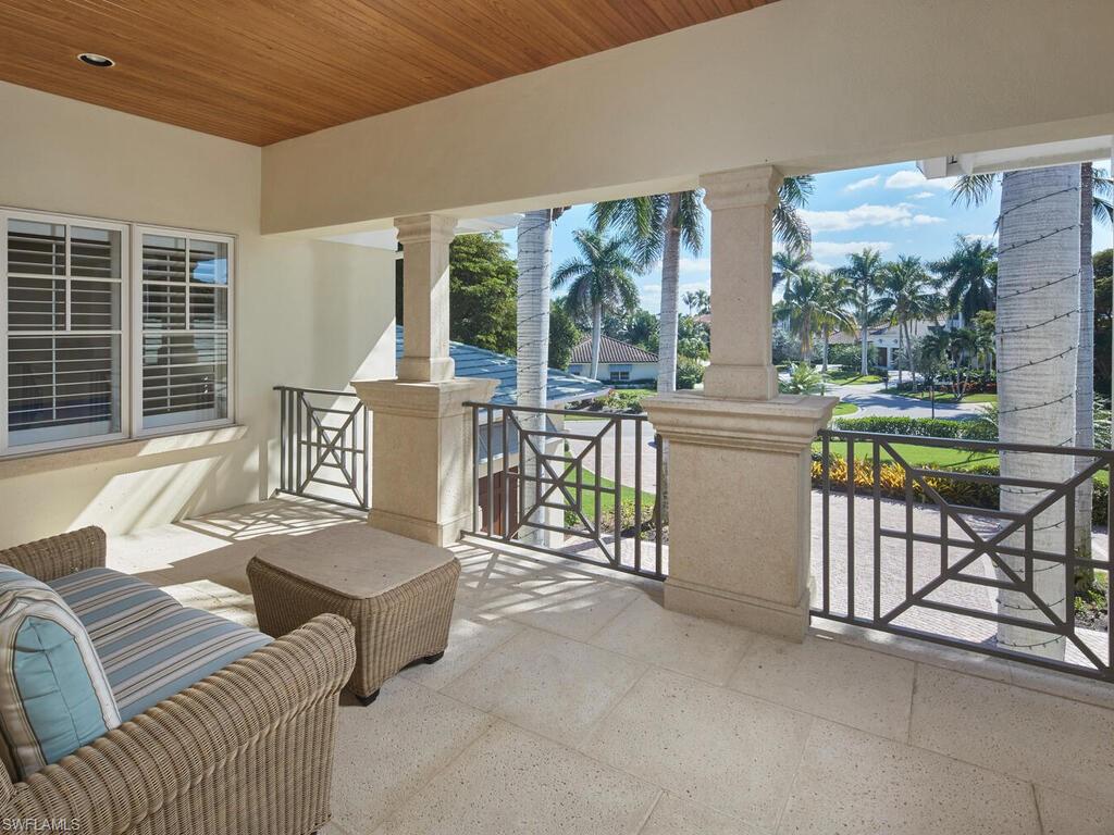 377 Pirates Bight Naples, FL 34103 - Photo 26 of 44 a living room with furniture and a large window