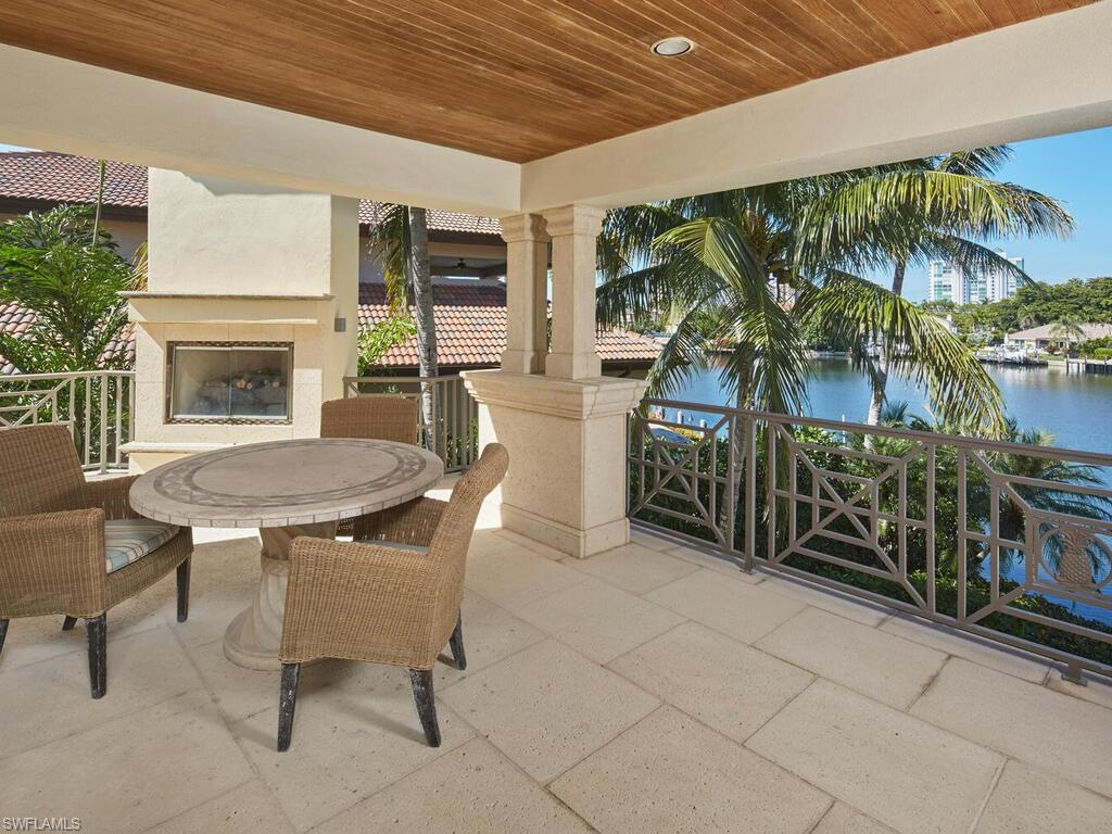 377 Pirates Bight Naples, FL 34103 - Photo 27 of 44 a view of a chairs and table in a patio
