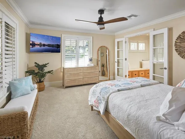 a bedroom with a large bed and a chandelier