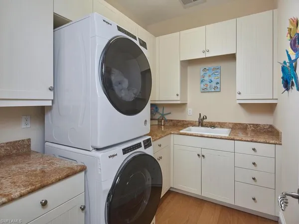 a kitchen with sink and cabinets