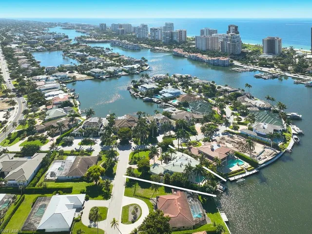 an aerial view of residential houses with outdoor space and lake view