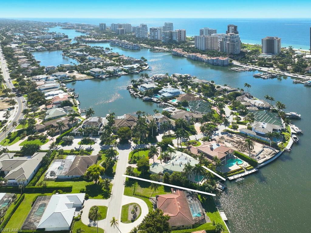 377 Pirates Bight Naples, FL 34103 - Photo 42 of 44 an aerial view of residential houses with outdoor space and lake view