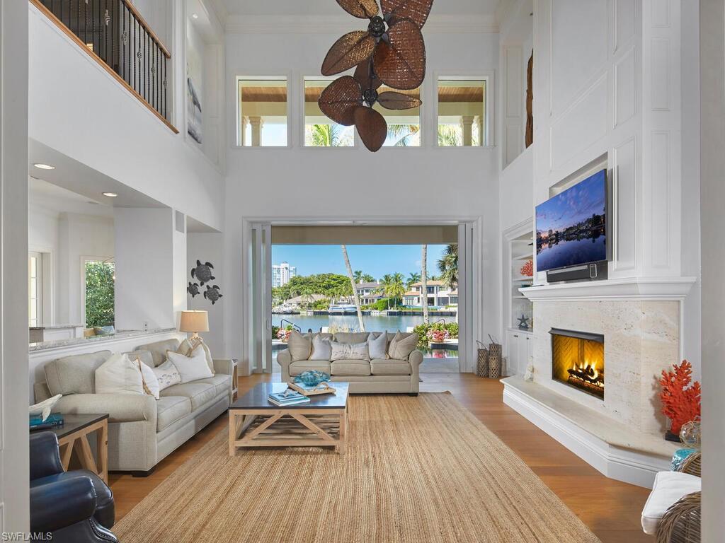 377 Pirates Bight Naples, FL 34103 - Photo 10 of 44 a living room with furniture and a fireplace