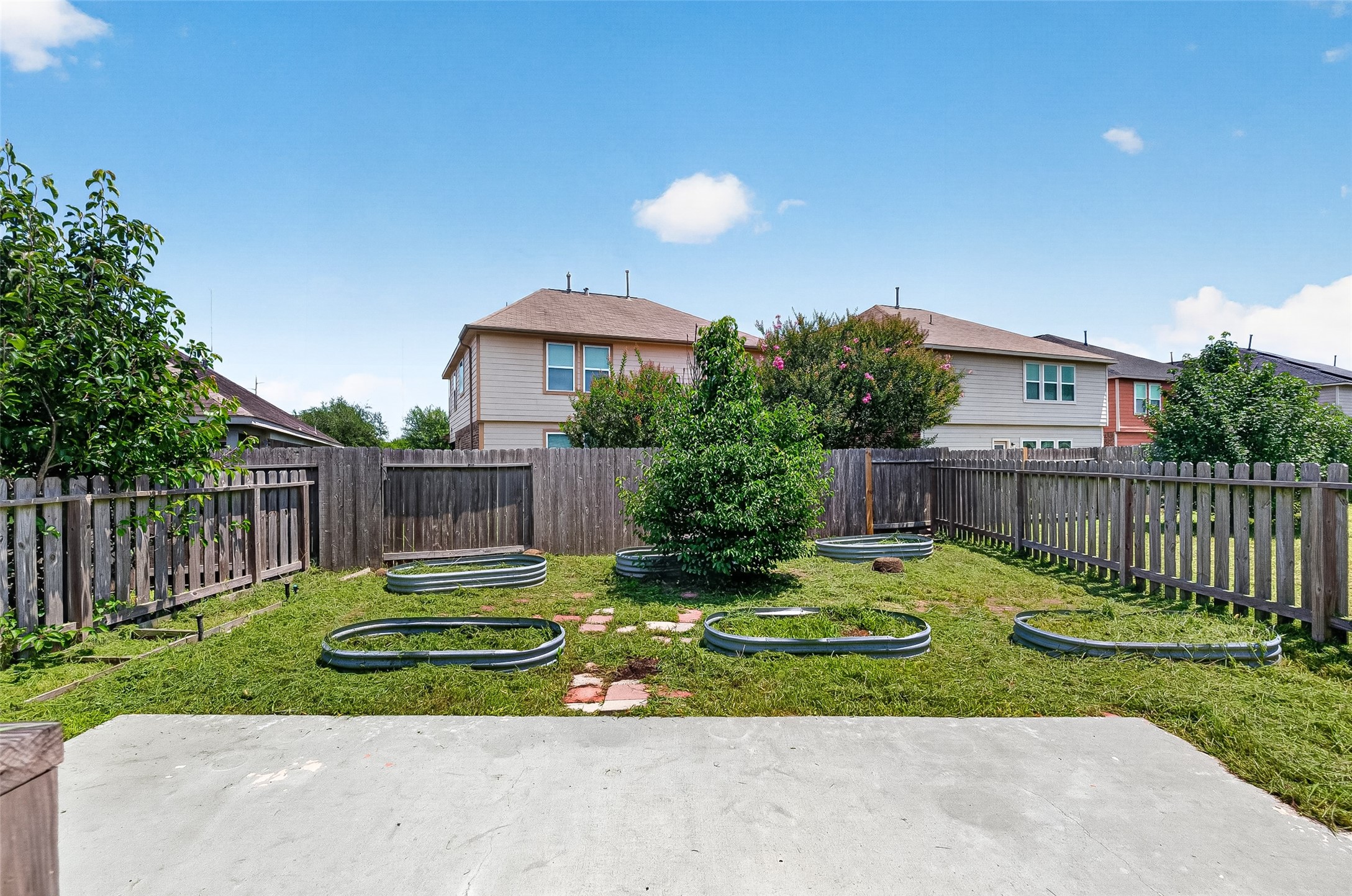 2702 Modano Court Fresno, TX 77545 - Photo 40 of 46 a view of a backyard with a garden and deck