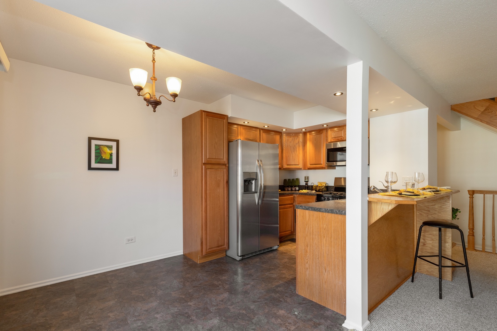 1446 Inverrary Lane, Unit 1446 Deerfield, IL 60015 - Photo 5 of 13 a view of a kitchen with a refrigerator and a stove top oven