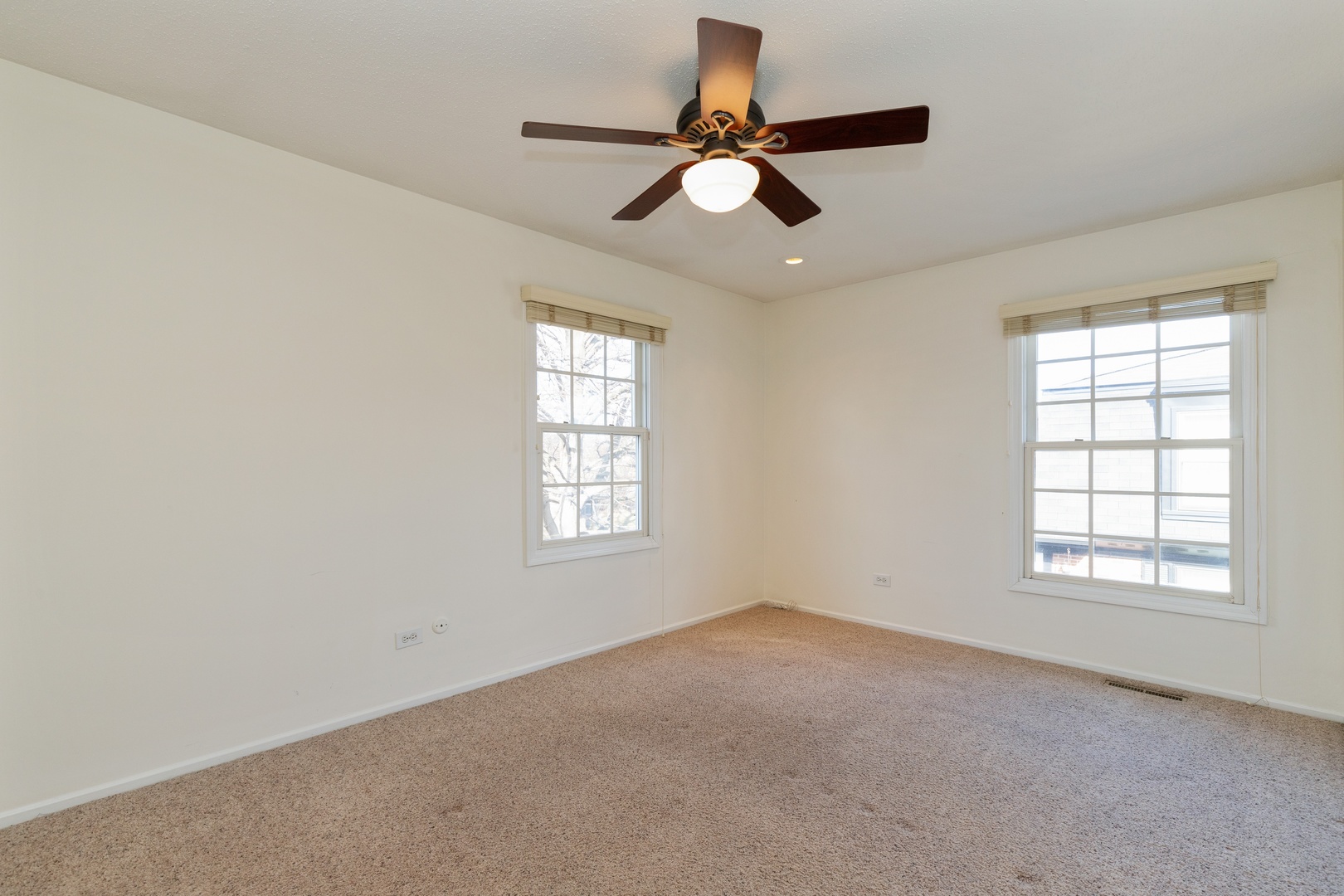 1446 Inverrary Lane, Unit 1446 Deerfield, IL 60015 - Photo 8 of 13 an empty room with a window and a fan