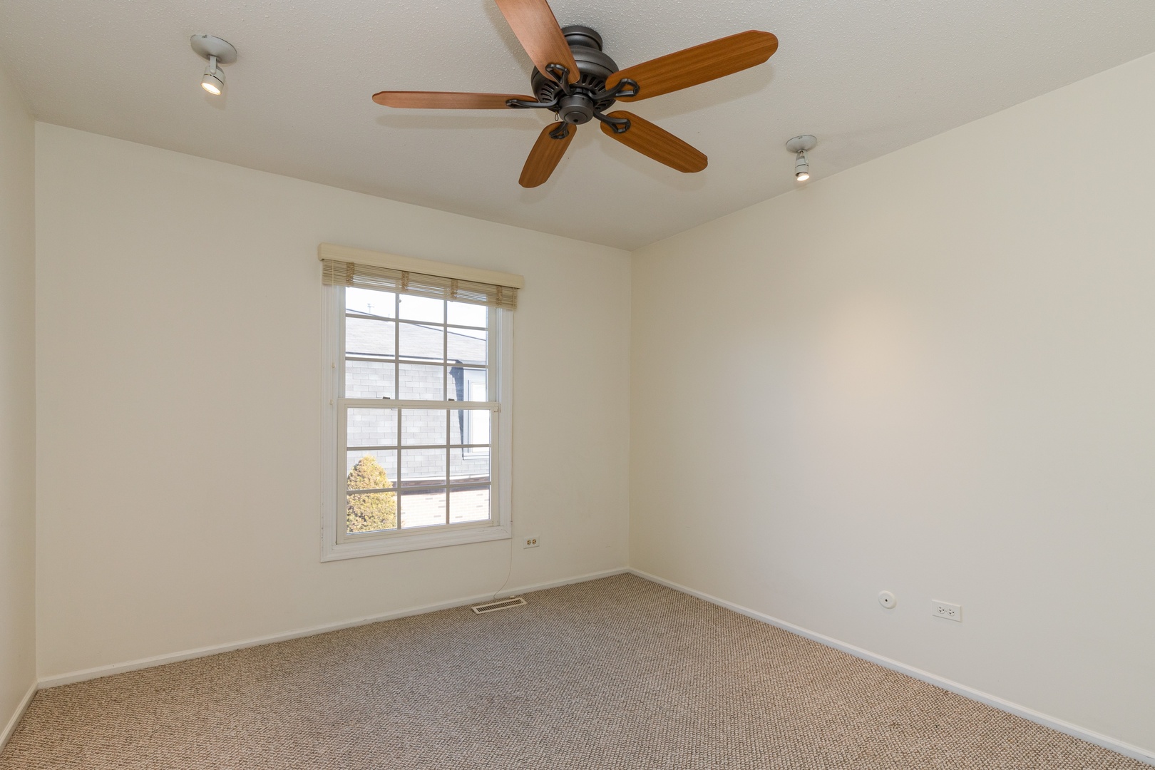 1446 Inverrary Lane, Unit 1446 Deerfield, IL 60015 - Photo 9 of 13 an empty room with a window and a fan