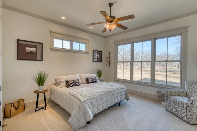 a bedroom with a large bed and a chandelier