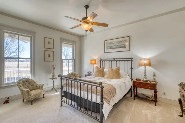 a bedroom with bed and a chandelier