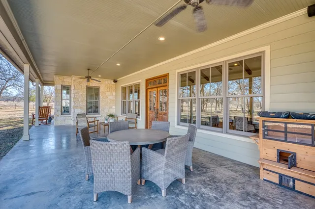 a room with pool table and large windows