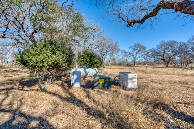 a view of yard with wooden fence
