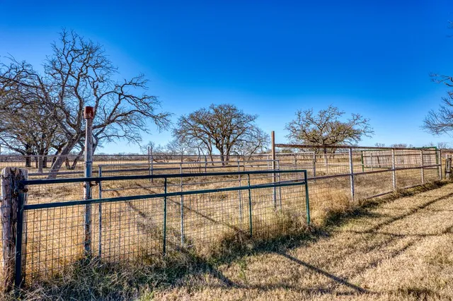 a backyard of a house with barbeque oven table and chairs