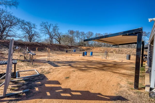 a view of a house with backyard and sitting area