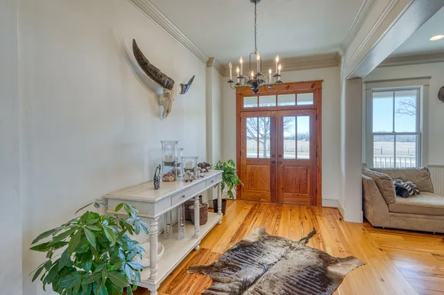 a spacious bedroom with a bed and a chandelier