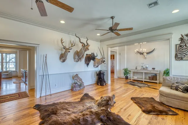 a living room with fireplace furniture and a wooden floor