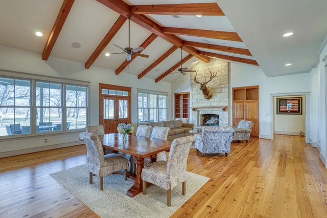 a living room with furniture fireplace and a table
