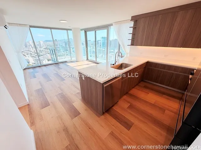 a kitchen with wooden cabinets and a large window