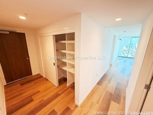 a view of hallway with wooden floor
