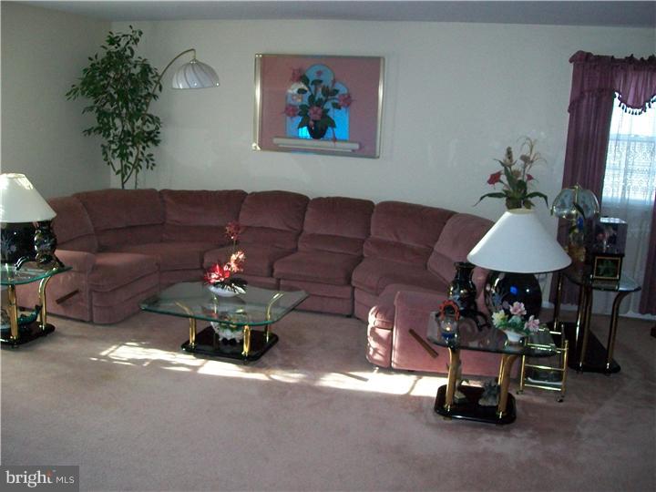 449 Doe Run Lane Springfield, PA 19064 - Photo 4 of 11 a living room with furniture and a chandelier