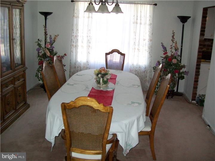 449 Doe Run Lane Springfield, PA 19064 - Photo 5 of 11 a view of a dining room with furniture and a chandelier