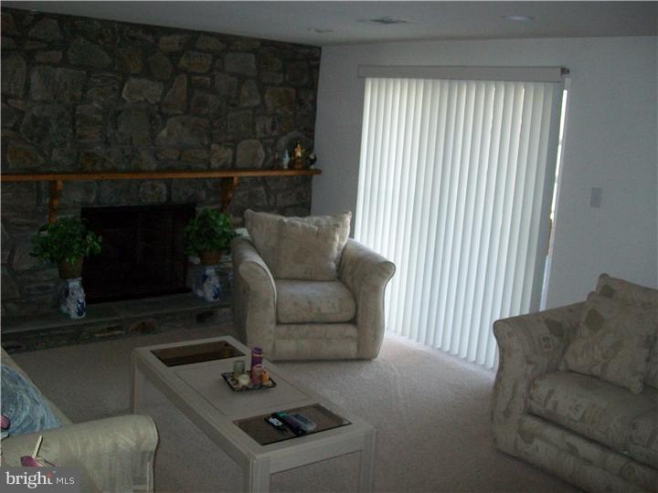 449 Doe Run Lane Springfield, PA 19064 - Photo 8 of 11 a living room with furniture and a fireplace