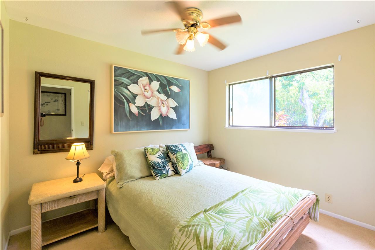 4025 Lower Honoapiilani Road Lahaina, HI 96761 - Photo 16 of 21 a bedroom with a bed and a painting on the wall