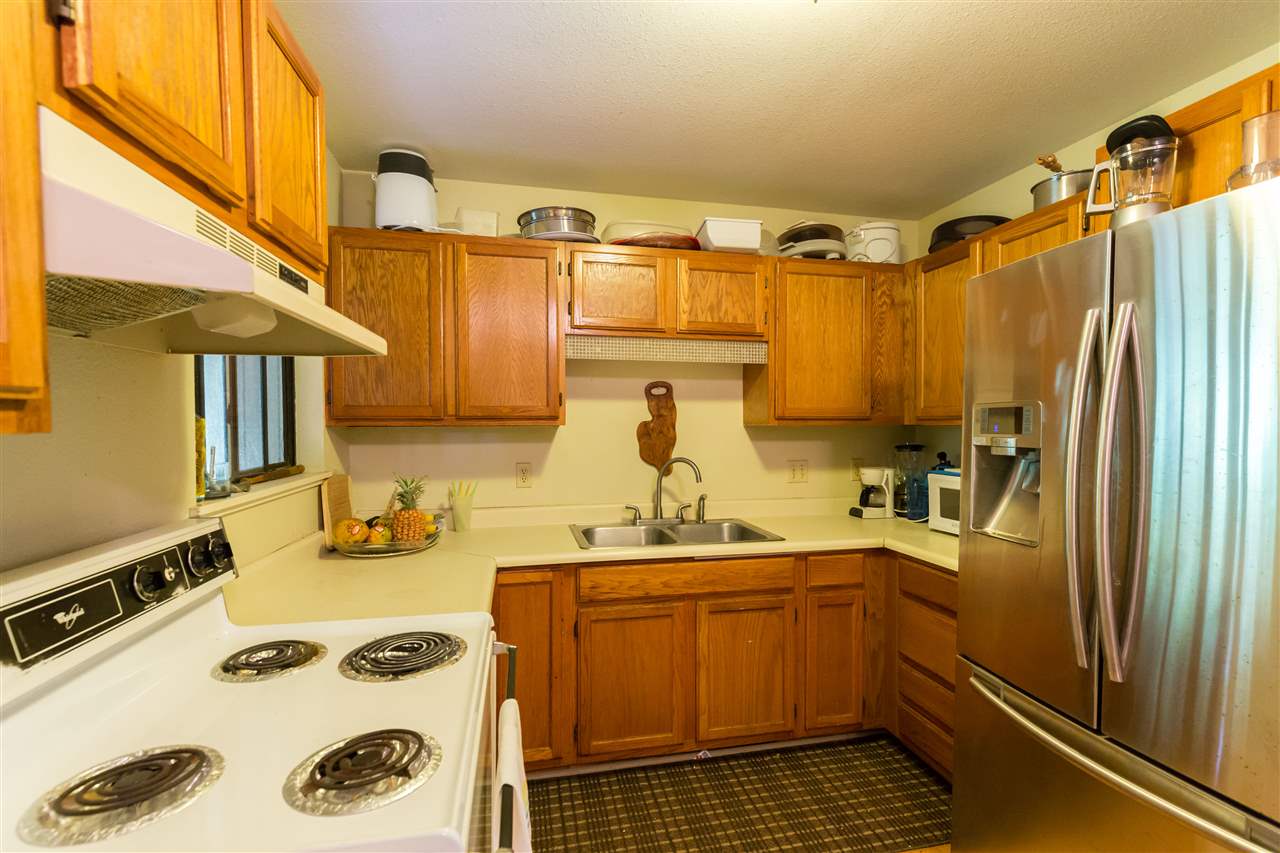 4025 Lower Honoapiilani Road Lahaina, HI 96761 - Photo 19 of 21 a kitchen with sink refrigerator and cabinets
