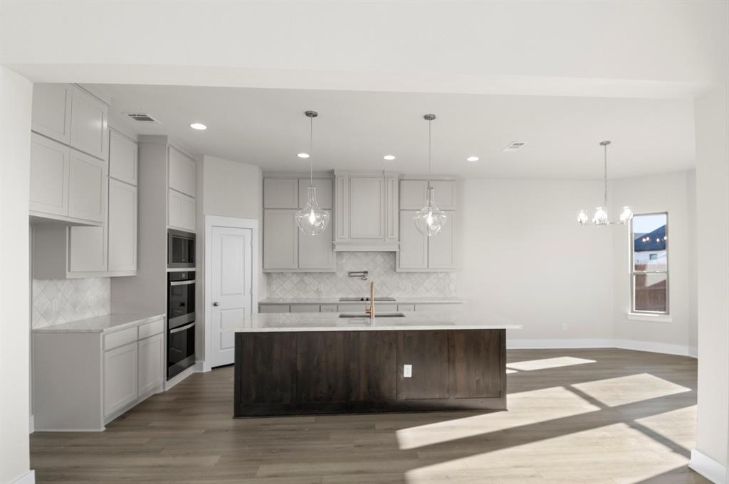 2131 Holborn Street Waco, TX 76655 - Photo 8 of 31 a kitchen with kitchen island a sink stainless steel appliances and cabinets