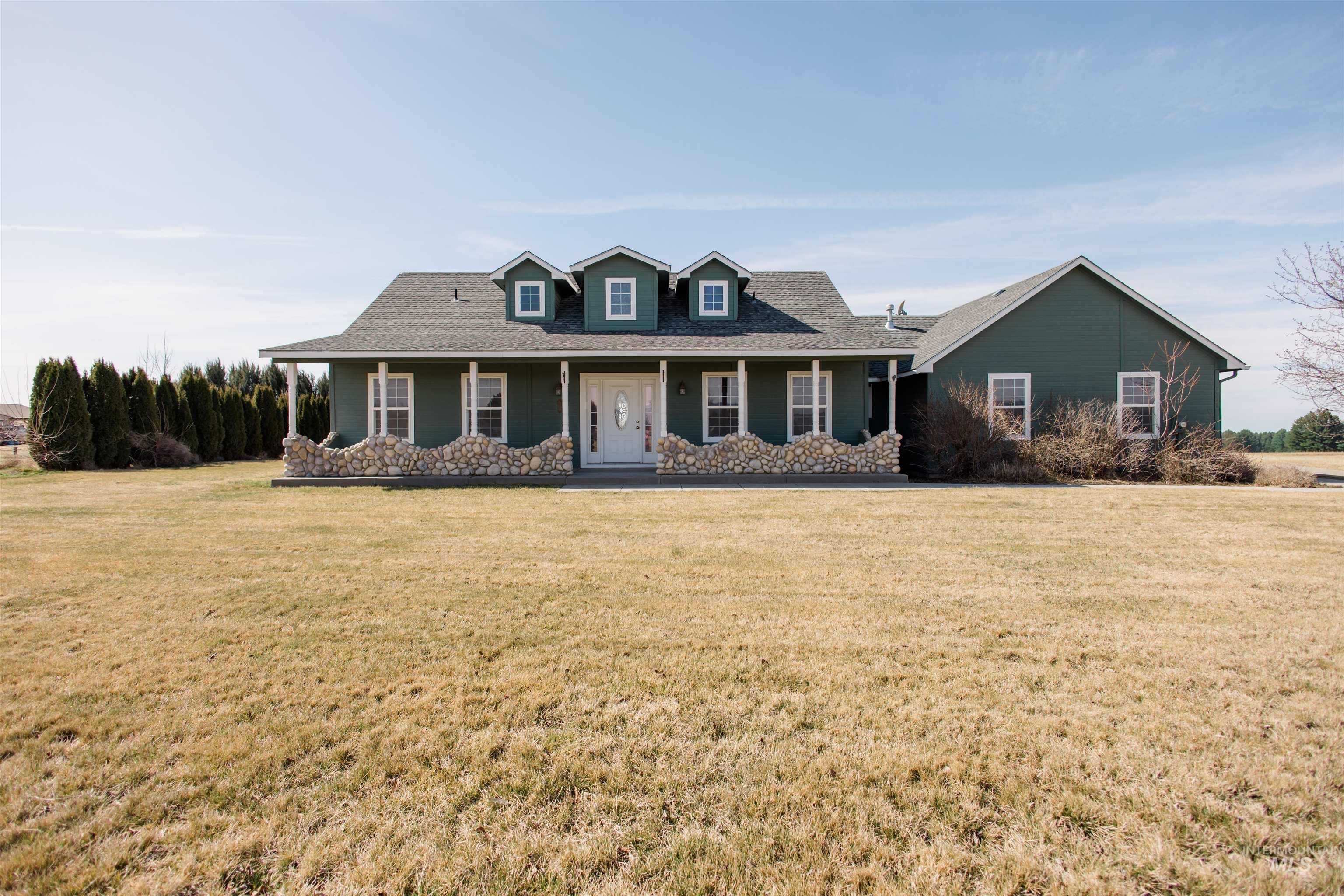 1571 Southeast Hamilton Road Mountain Home, ID 83647 - Photo 1 of 50 View of front of house with a porch, a front lawn, and roof with shingles